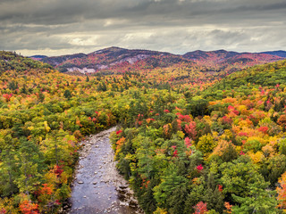 New Hampshire - Kancamagus Highway in Autumn - Swift River near the Albany Covered Bridge in the...