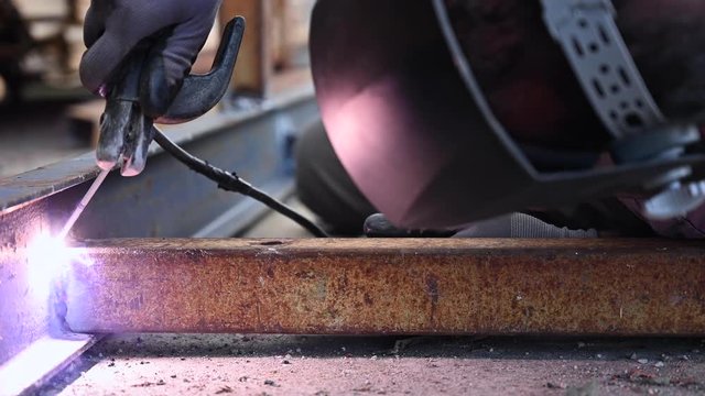 Close-up of the welding process of two metal parts .
