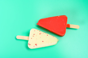 red and white chocolate outers popsicles on green background