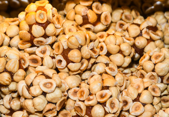 Turkish fruit and nut candy. Scattered pistachio and almond nuts.