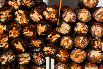 Cevizli sucuk made by dipping a string with walnuts into a grape molasses mixture