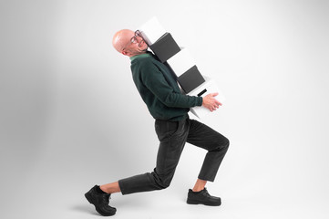 Tired serious man in black wear holds and carries black and white boxes