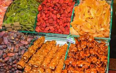 Cevizli sucuk made by dipping a string with walnuts into a grape molasses mixture