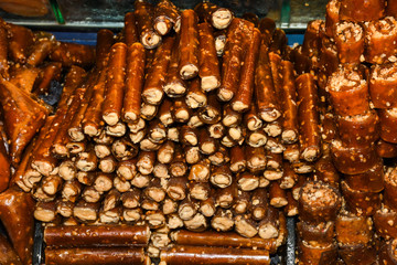 Cevizli sucuk made by dipping a string with walnuts into a grape molasses mixture