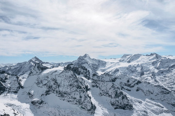 Obraz na płótnie Canvas Snow Covered Mountains Against Clouds