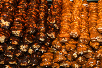 Cevizli sucuk made by dipping a string with walnuts into a grape molasses mixture