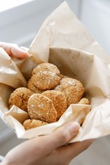 plate of cookies in heands on parchment paper