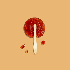 Lollipop made at home from natural ingredients on a beige background with a clear shadow . Concept of environmental products. Food photo, top view