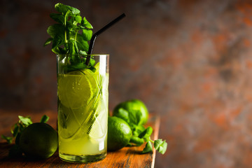 Mojito cocktail with lime and mint on the rustic background. Selective focus. Shallow depth of field.