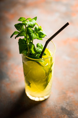 Mojito cocktail with lime and mint on the rustic background. Selective focus. Shallow depth of field.