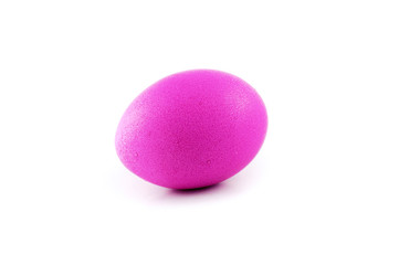 Pink or magenta colored easter egg isolated on white background, colored by easter bunny