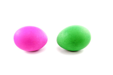 Two easter eggs, red and green, isolated on white background, colored by easter bunny