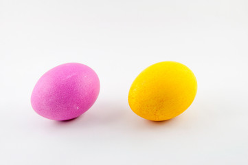 Two easter eggs, pink and yellow, isolated on white background, colored by easter bunny