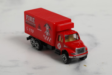 fire engine toy on marble white background