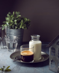 Coffee glass with milk over dark background