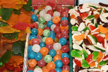 Colorful multicolored dragee, chocolate covered nuts drops. fruit sauce