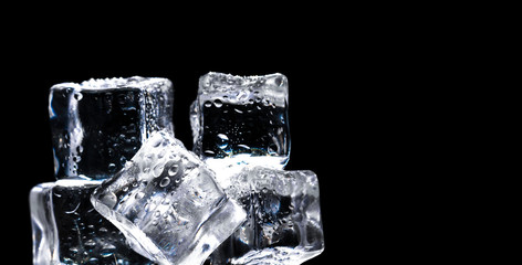 ice cubes with drops of water on a black background