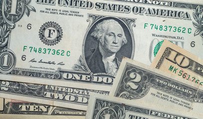 Closeup of the one dollar two dollar and ten dollar.