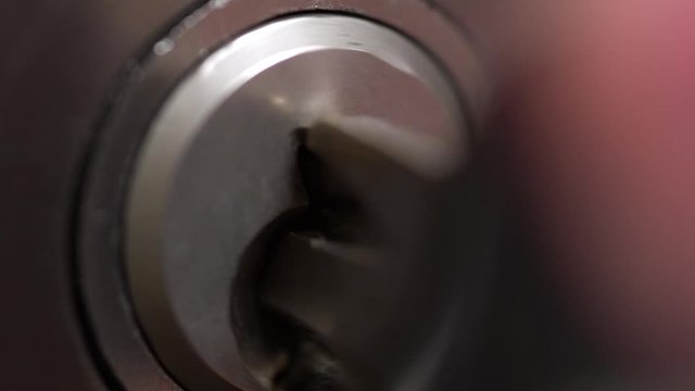 Macro detail of key put into a keyhole and turned right