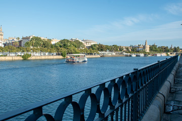 Fototapeta na wymiar Sevilla, Spain, November 14, 2019: Romantic river cruises with t