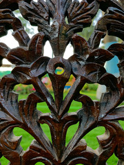 Old wood design and green garden behind it.