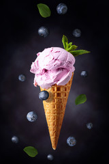 Blueberry ice cream in waffle cone.