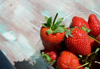 organic and fresh strawberries on a  wooden background