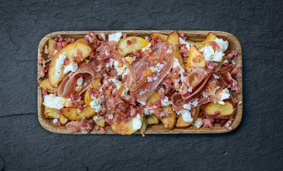 Broken eggs with ham and egg and potatoes.
Tapa of restaurant bar in Spain.