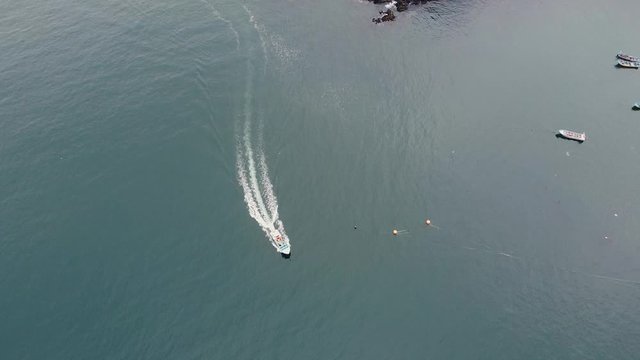 Aerial drone view directly above motor speed boat on a Pacific ocean. Bahia Mansa, Pacific coast, Chile