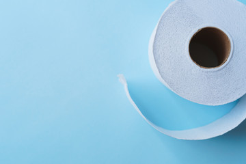 Roll of toilet paper on a pastel blue background coronavirus design