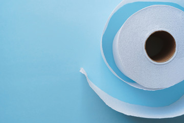 Roll of toilet paper on a pastel blue background coronavirus design