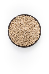 Sunflowers seeds in round bowl on white background, top view