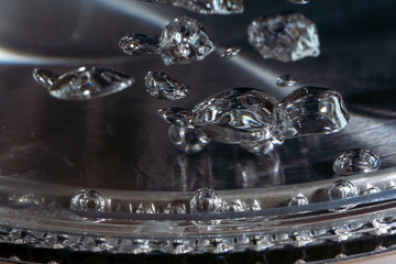 boiling water in a teapot, water bubbles in macro