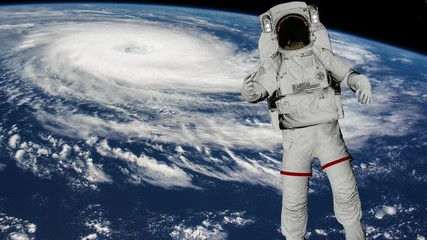 Astronaut Spacewalk, Astronaut shows thumbs up in the open space. Earth with a Hurricane. Elements of this video furnished by NASA.