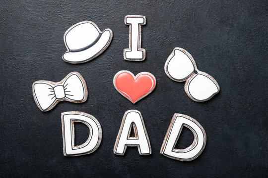 Happy father's day concept. Cookies on a black background. Text i love dad.