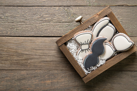 Happy father's day concept. Tasty cookies in a box on a wooden background. Place for text