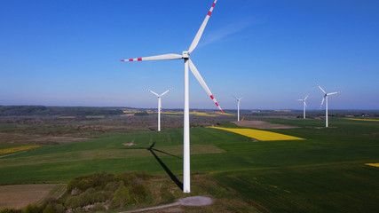 Windmills generate electricity in a fields. Pomerania, Poland