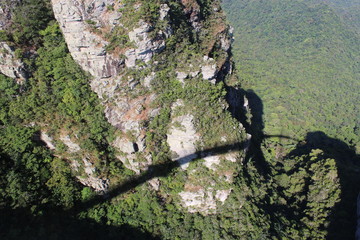 Shadow of the Sky Bridge over lush green mountains at Langkawi, Malaysia