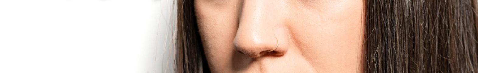 Close up of young woman with nose piercings