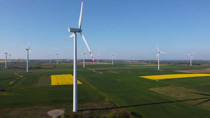 Fototapeta na wymiar Wind turbines farm. Windmills surrounded by fields in spring, Pomerania, Poland.