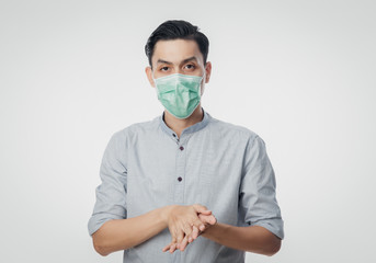 Young Asian Businessman wearing hygienic mask and washing hands with hand sanitizer gel, Prevent...