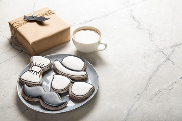 Happy Father's Day concept. Tasty cookies and cup of coffee on wooden background