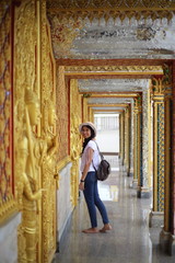 Woman standing at the line of Buddha statue in Wat Tha Sung, Uthai Thani, Thailand.