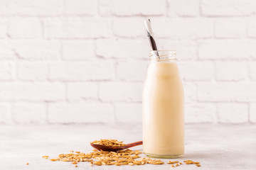 A bottle of oat milk and oats.