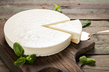 Tasty homemade cheesecake on a wooden background. Place for text.