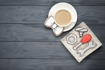 Happy Father's Day concept. Tasty cookies and cup of coffee on wooden background