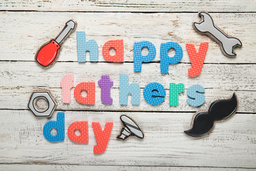 Happy father's day concept. Cookies on a black background. Text happy father's day