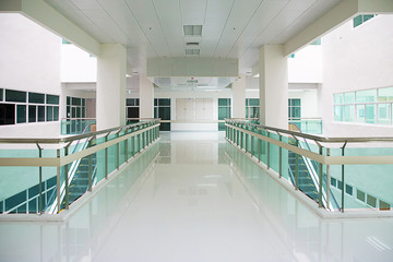 Walkway office building background business lobby reception hall interior. Background interior view looking out toward to empty walkway and entrance doors and glass curtain wall