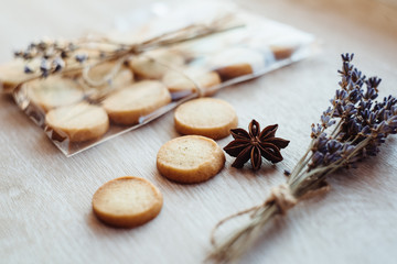 Aromatic lavender cookies, handmade. French cuisine. Shortbread cookies and bouquet of lavender flowers, on light wooden table. Gift with your own hands.