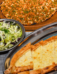 Traditional Turkish pizza, called Lahmacun, being prepared with meat, onion and parsley